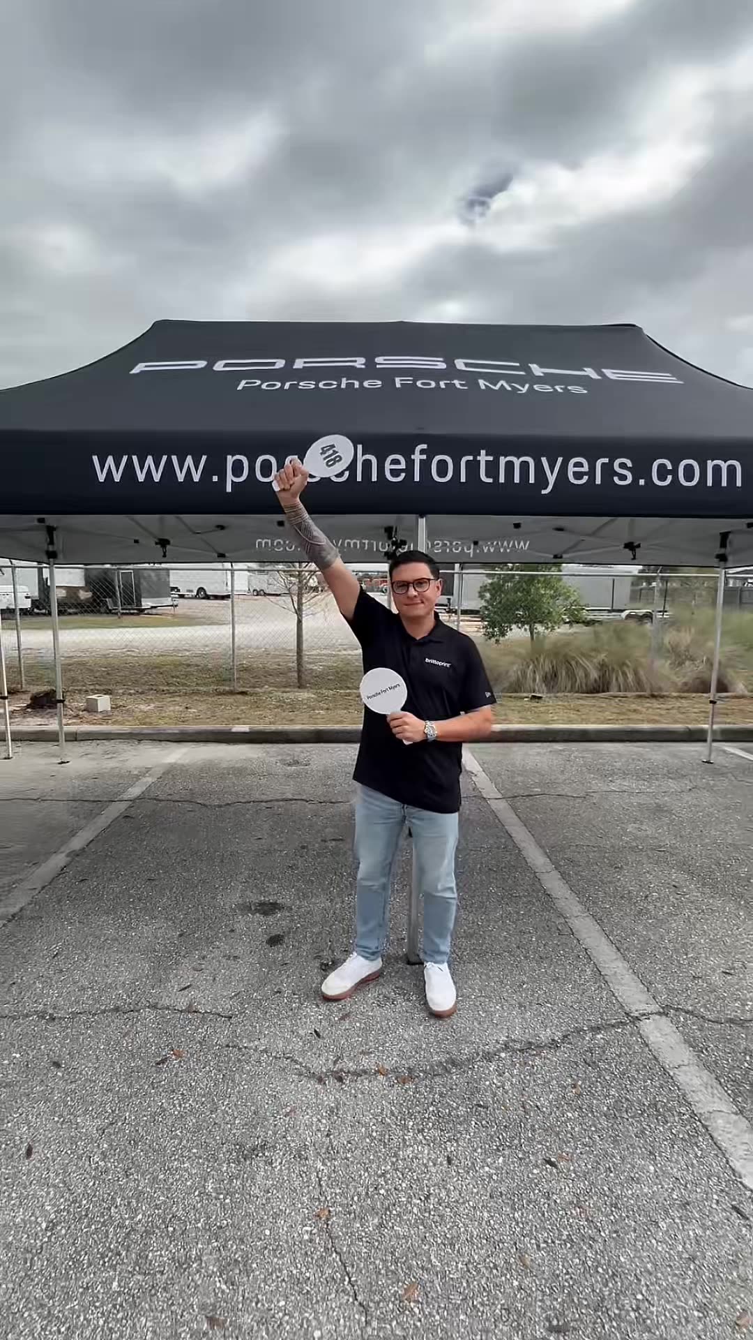 Porsche Fort Myers custom canopy tent with branded auction paddles — manufactured at Brittoprint, Lehigh Acres FL