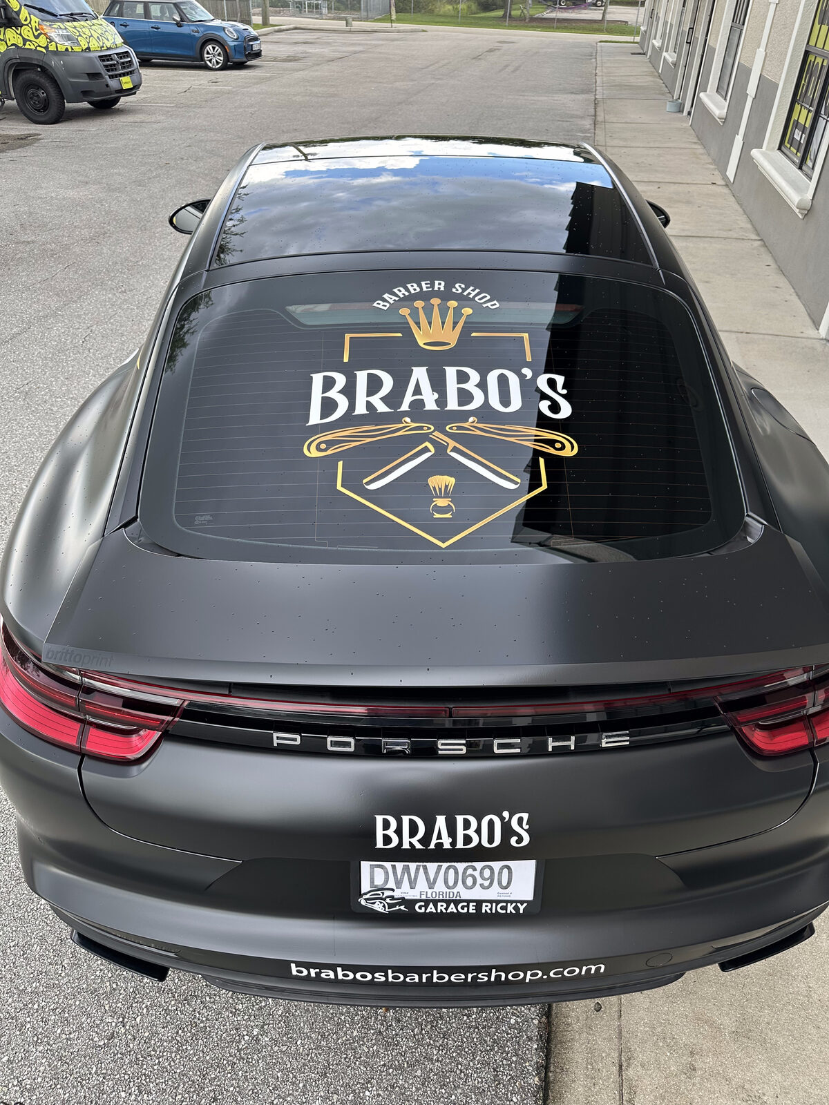 Real install detail — Brabo's Barbershop crest, lightning bolts and clean brand typography on the Porsche Panamera by Brittoprint. © 2026 Brittoprint.